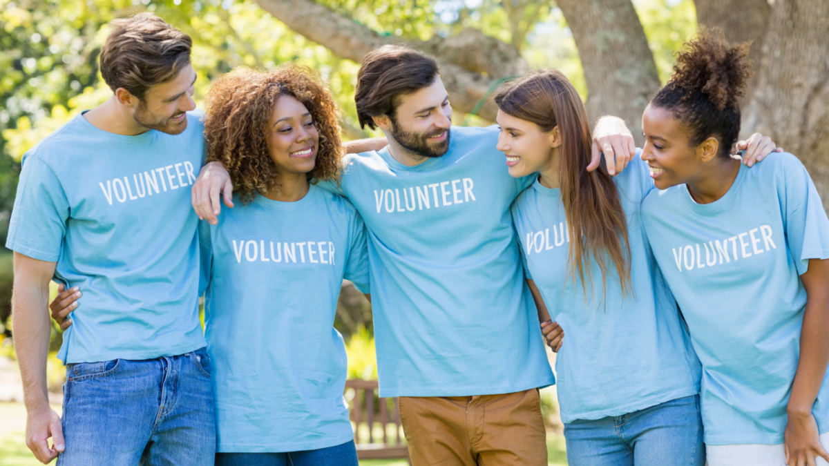 a group of volunteers wearing green shirts that say volunteer 