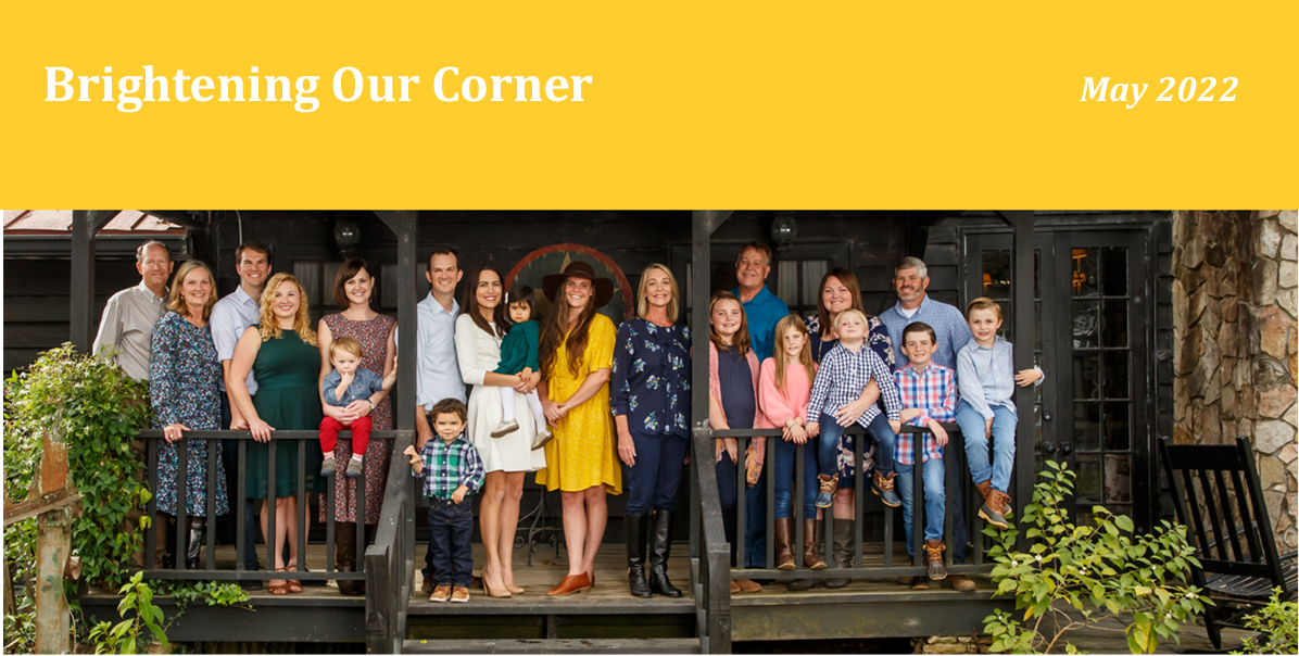 banner reading, "Brightening our corner" with picture of a large family underneath