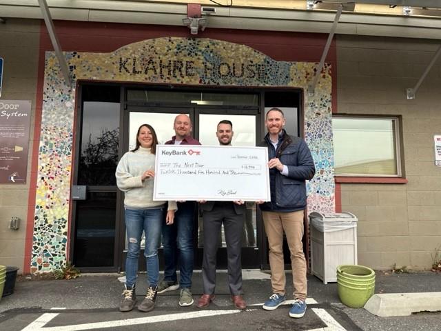 KeyBank and The Next Door Team shown with Grant Check.