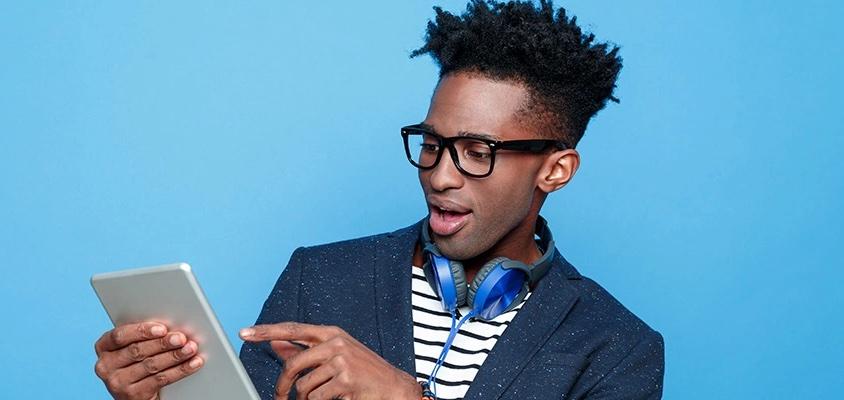 Young black make holding a tablet.