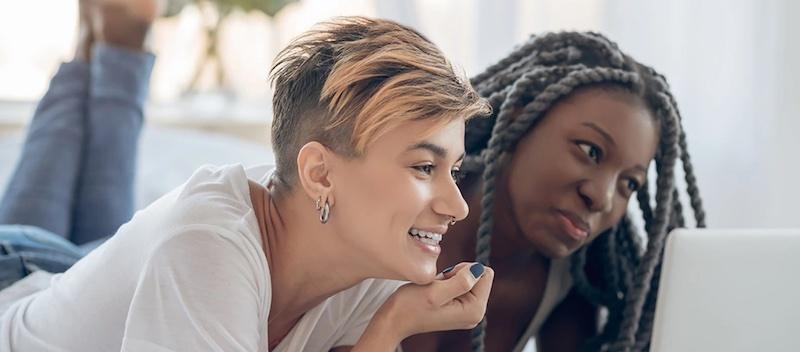 Two women viewing a laptop.