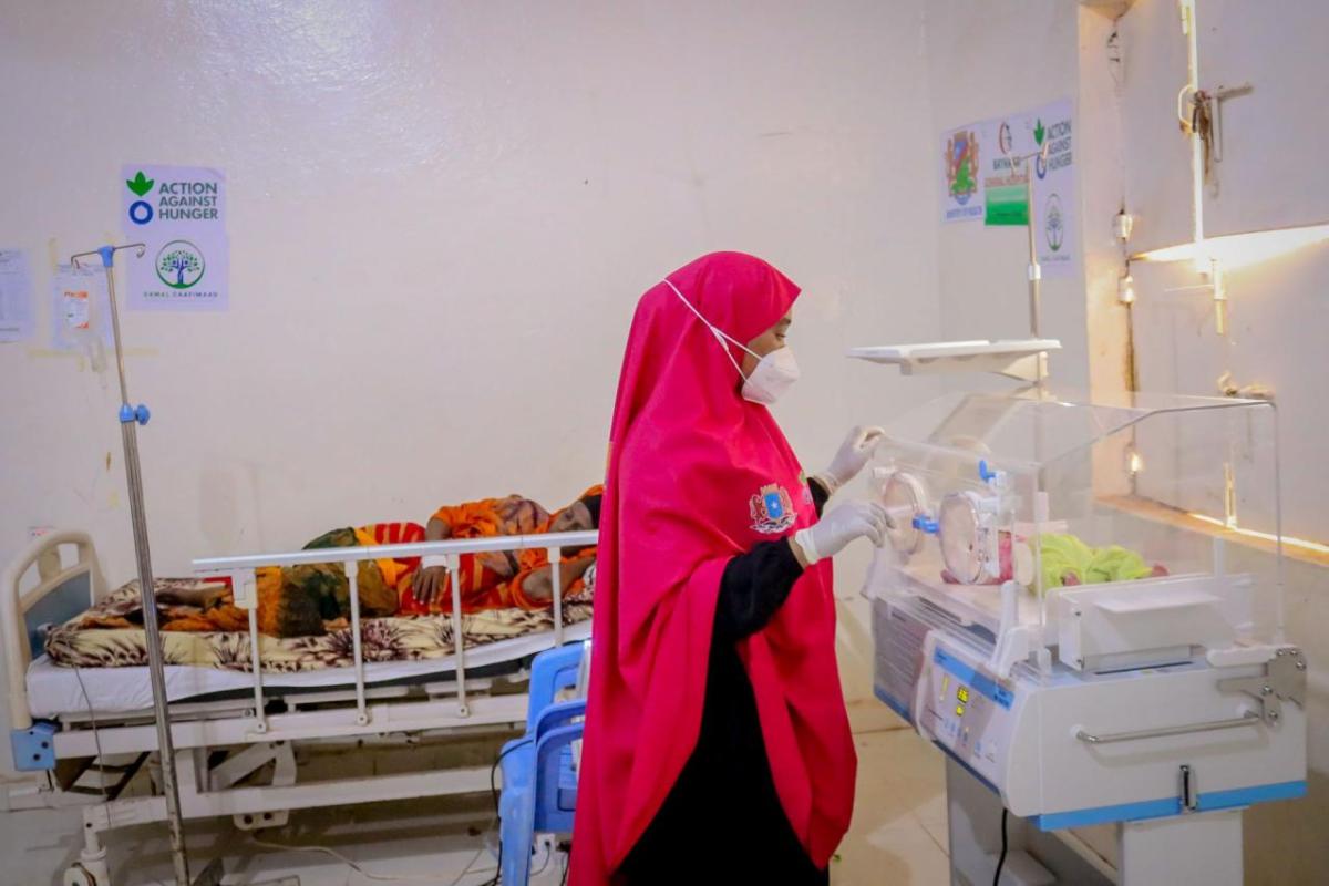 A nurse attends to Maryan and her baby.