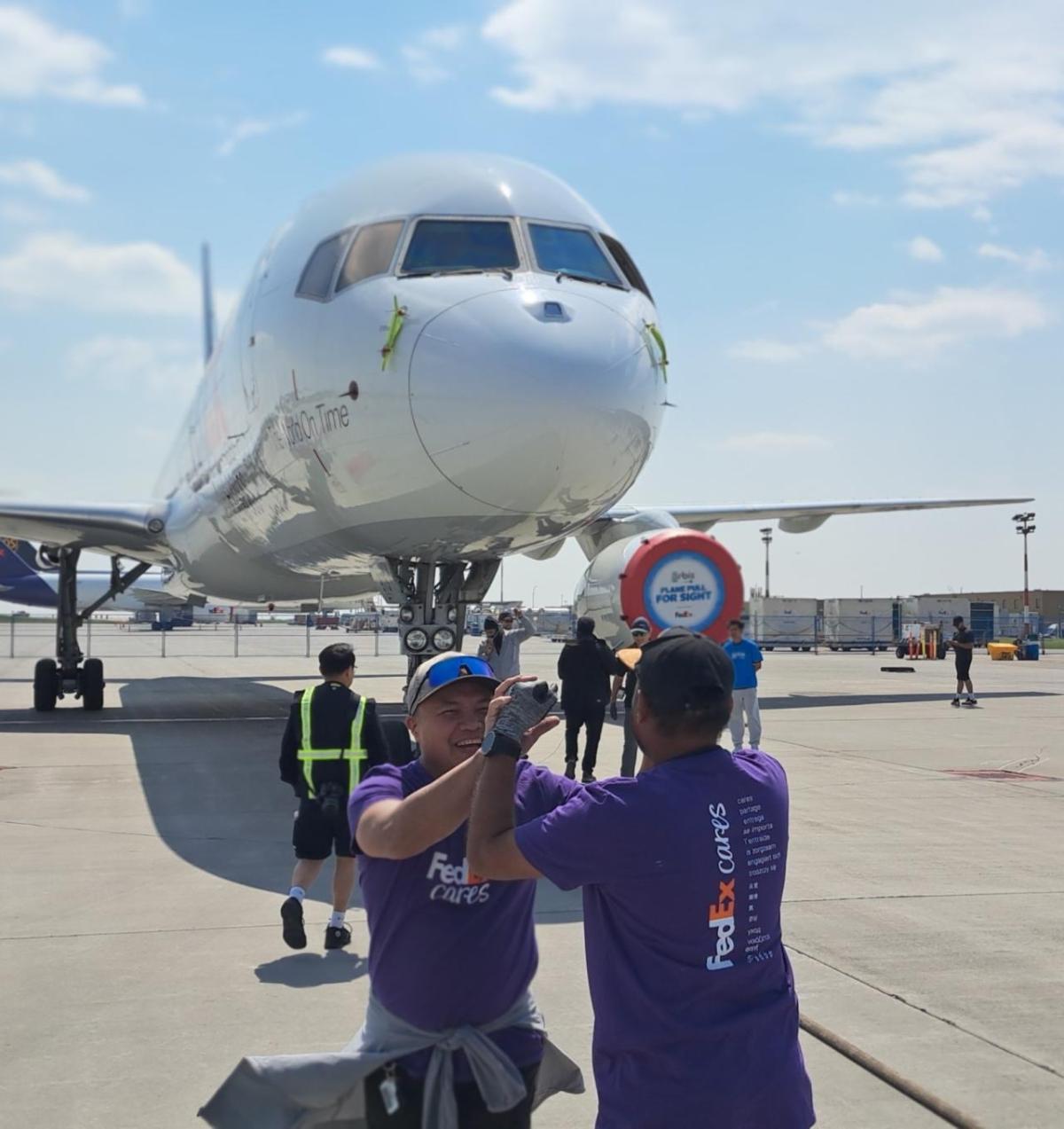 High-fives next to plane