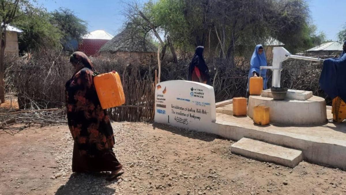 Owliya carries water home from the well. 