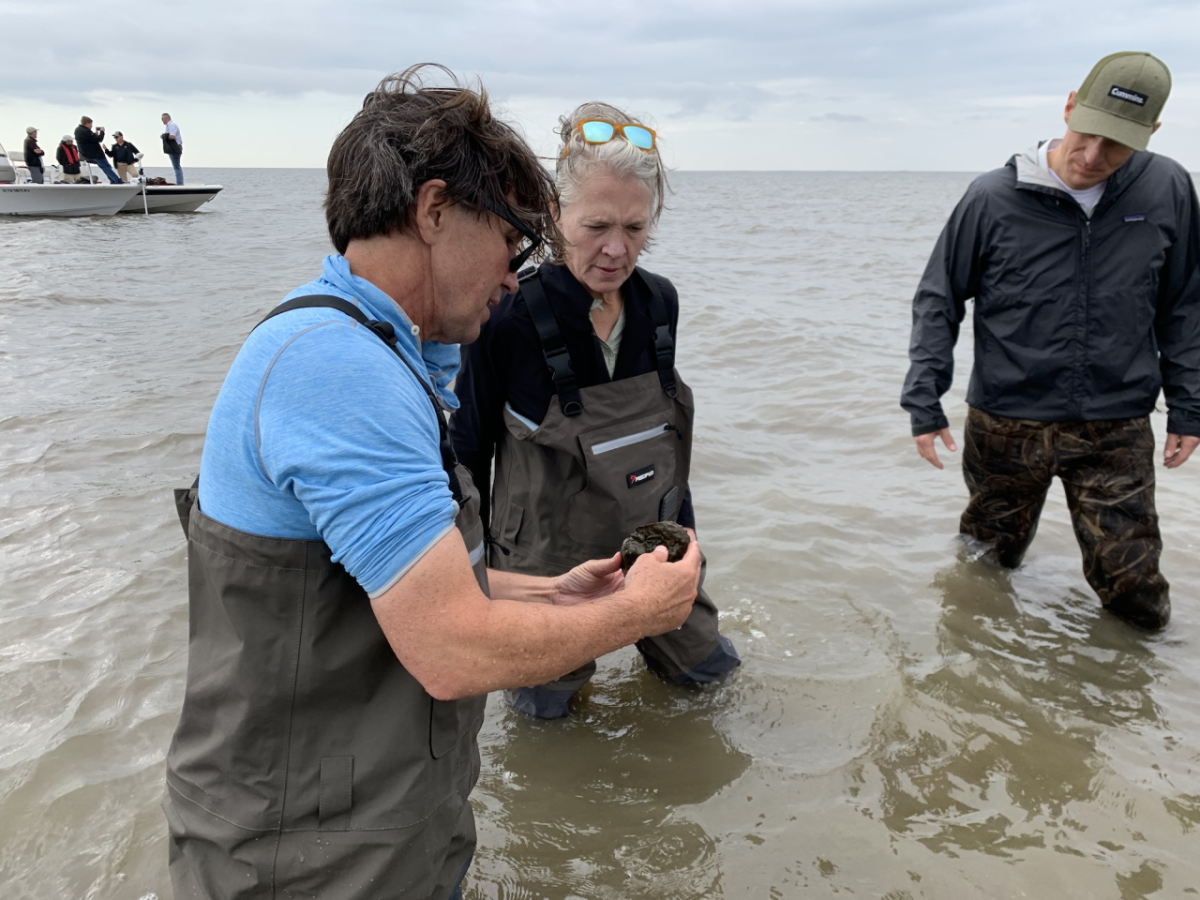 The Nature Conservancy’s Seth Blitch (left) discusses the oyster reef project with Mary Chandler (center), Vice President – Community Relations and Corporate Responsibility, and Zach Gillen (far right), General Manager – Cummins Sales and Service North America.