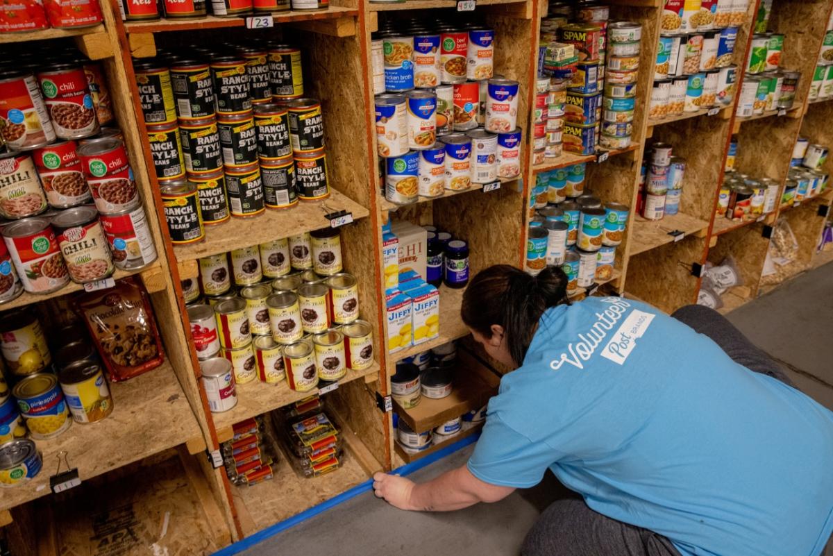 Post Consumer Brands employee, Melissa Hansen, preps a space for painting while volunteering on a service project