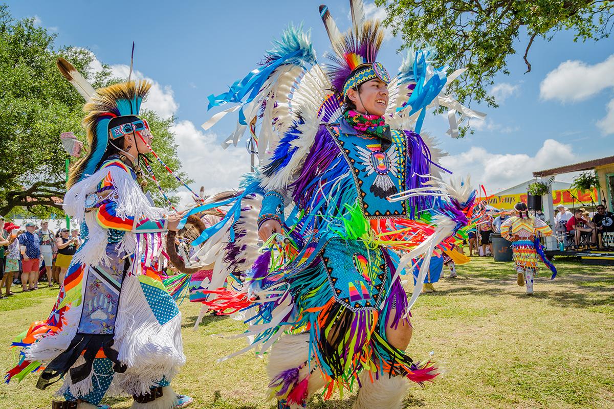 Native Americans wearing traditional dress 