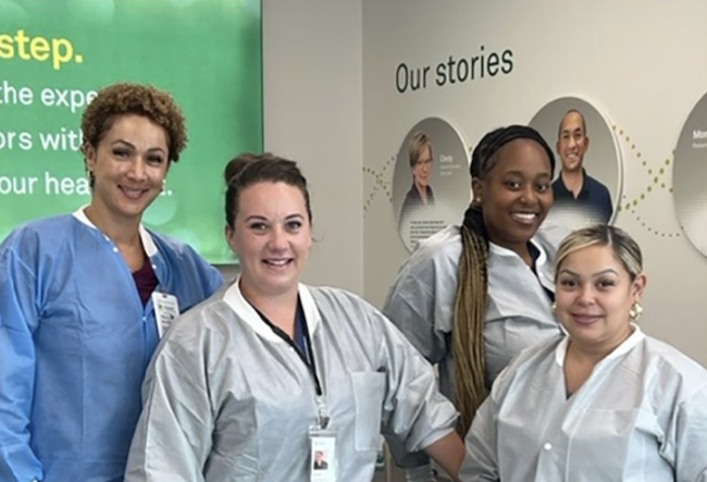 Four healthcare professionals stood together smiling