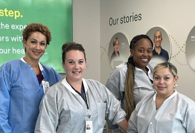 Four healthcare professionals stood together smiling 