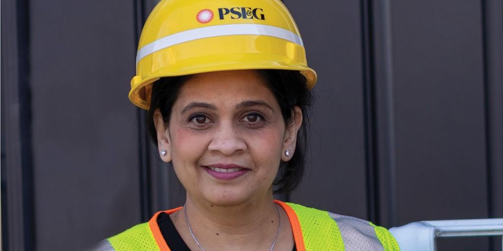 PSEG female employee wearing a hardhat and safety vest.
