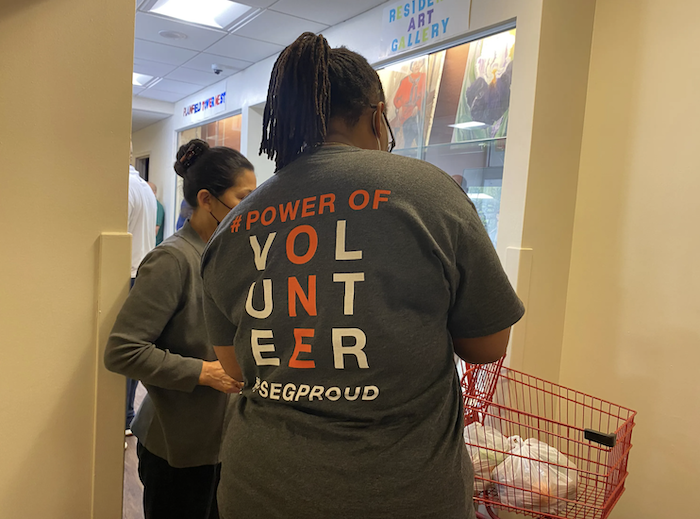 PSE&G volunteers prepare food bags.