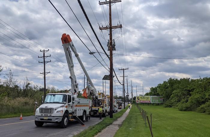 Photo showing PSEG crews updating power lines. Cherry picker truck is next to a telephone pole.