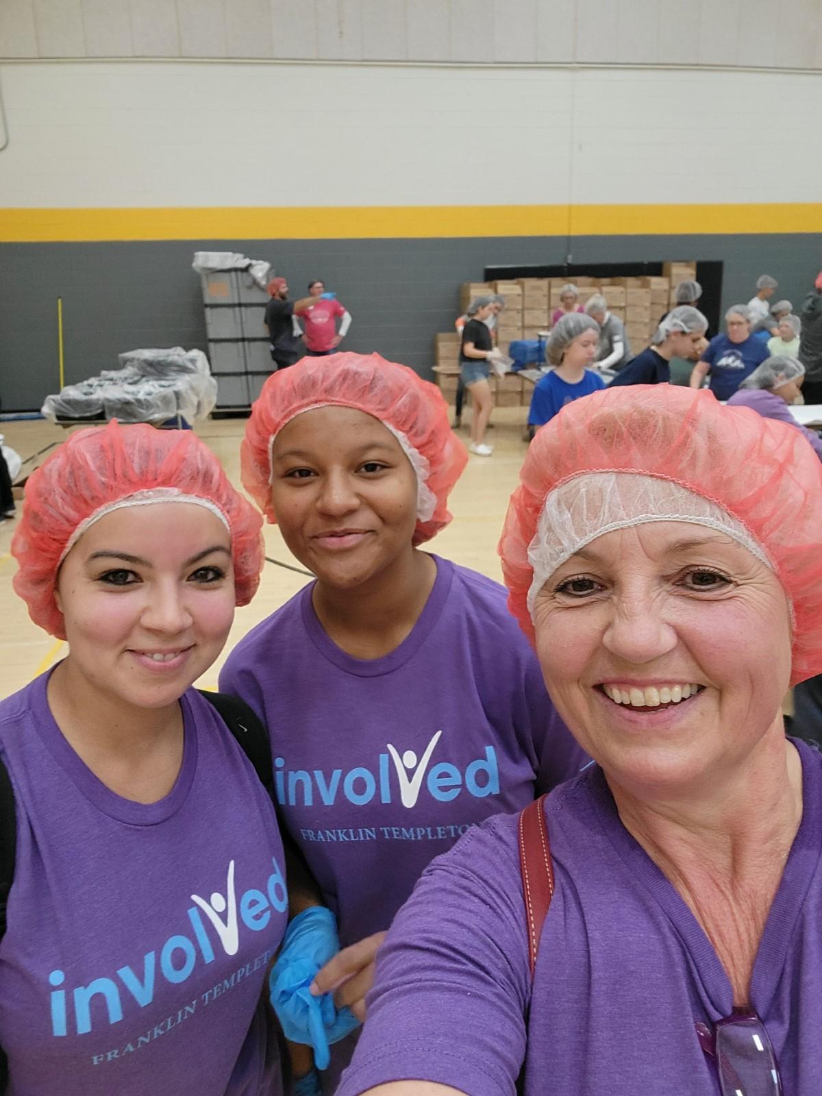 3 volunteers with hair nets