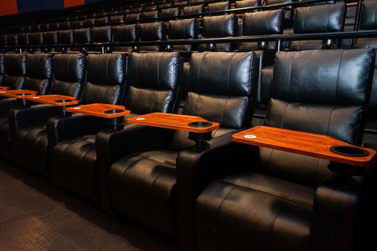 empty rows of leather seats in an auditorium 