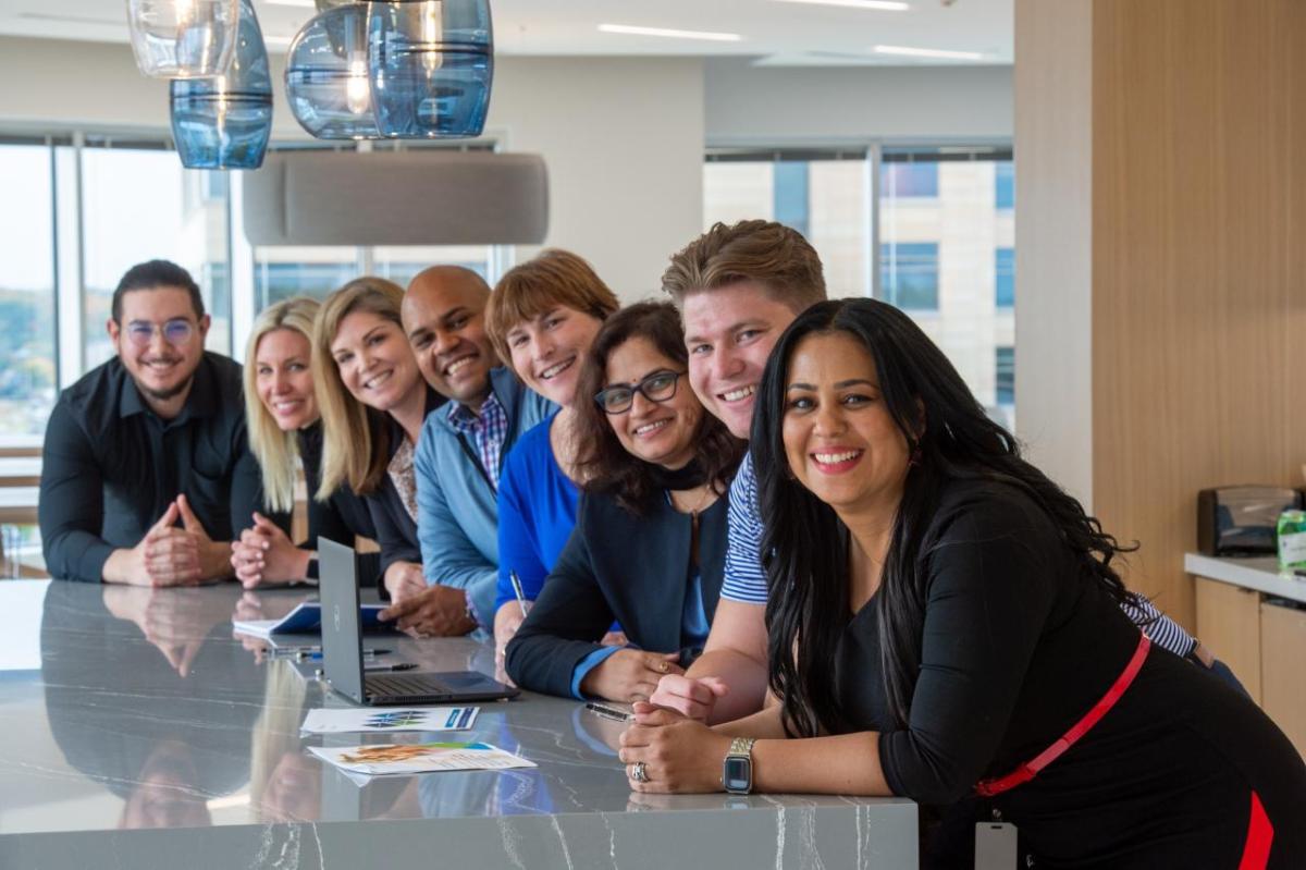 Pentair employees are helping to drive positive impacts across its business. Image is courtesy of Pentair. Pentair employees gather at table