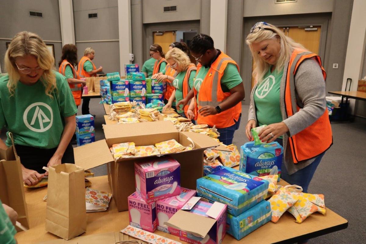 Women packaging menstrual health management supplies 