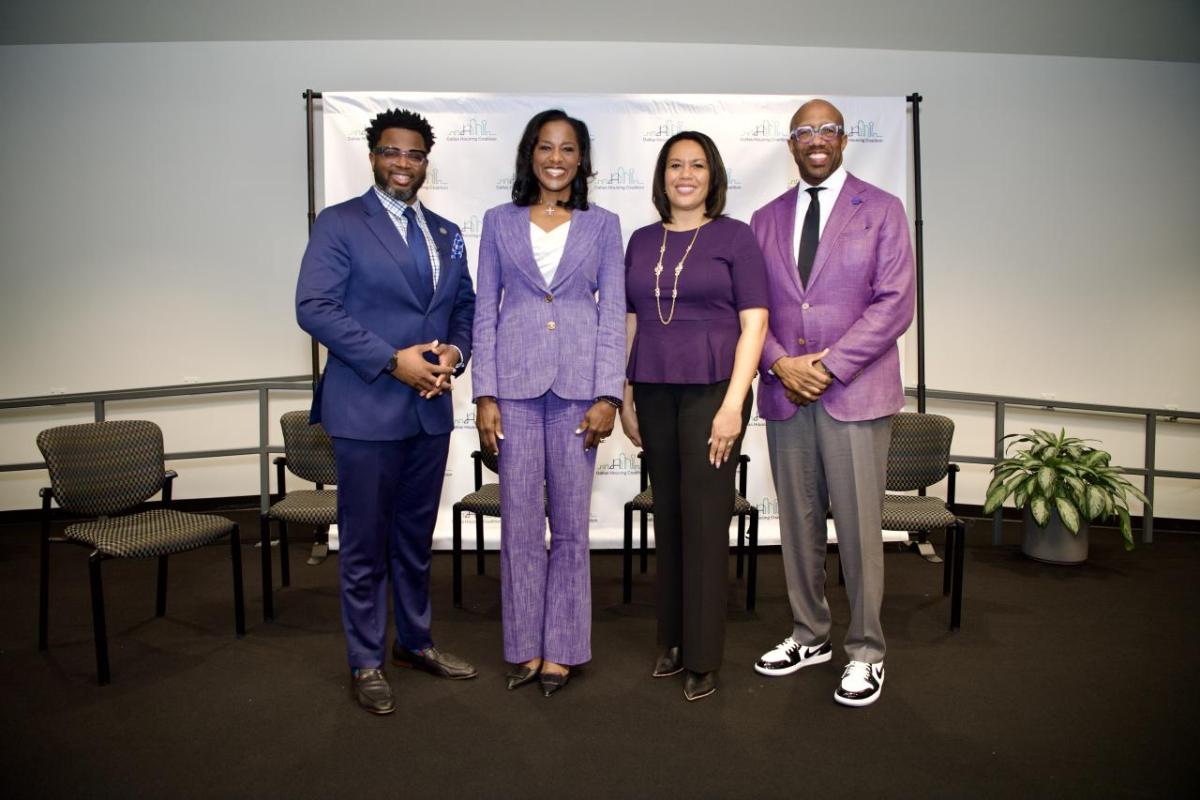 (From left to right) Marcedes Fuller from T.D. Jakes Foundation, Kristy Fercho and Tanya Sanders from Wells Fargo and President Michael Sorrell from Paul Quinn College join to celebrate a new $1.5 million grant from T.D. Jakes Foundation and Wells Fargo, which will enable Paul Quinn College to bring a transformative housing and community vision to life. Photo Credit: Kelly Alexander/Paul Quinn College Four people standing in a conference room