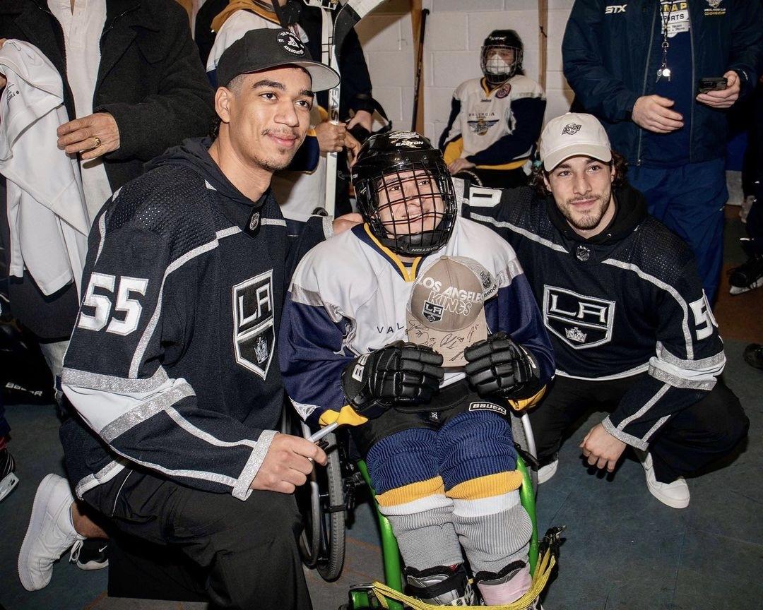 LA Kings players pose with a child from SNAP Flyers Hockey Club.
