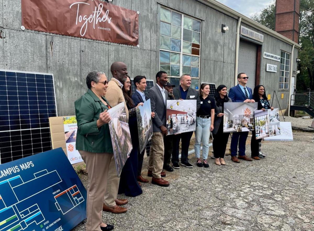 Baltimore City Community Resiliency Hub project participants with images of future plans