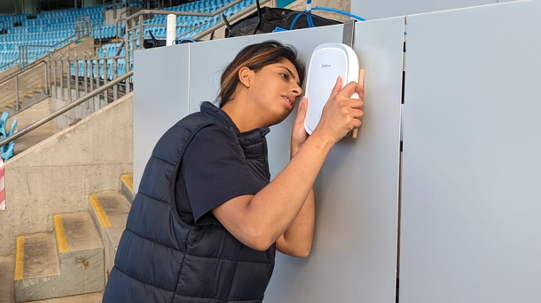 Noor Zafar installing a piece of equipment.