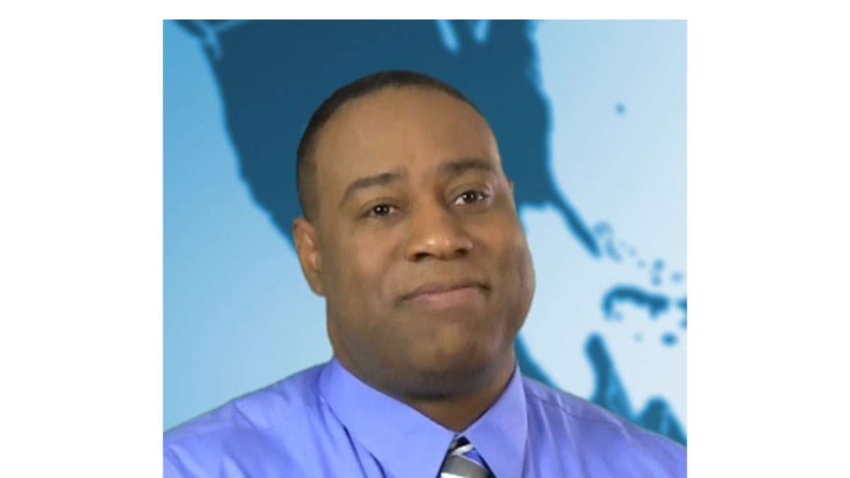 Headshot of a person against a blue background