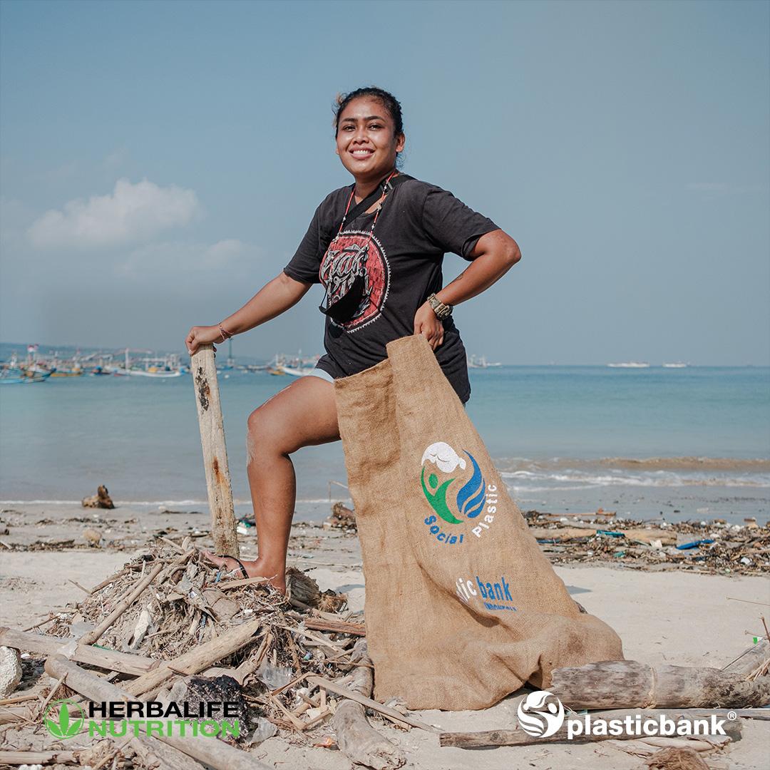 Woman with a bag of trash cleaned from the beach