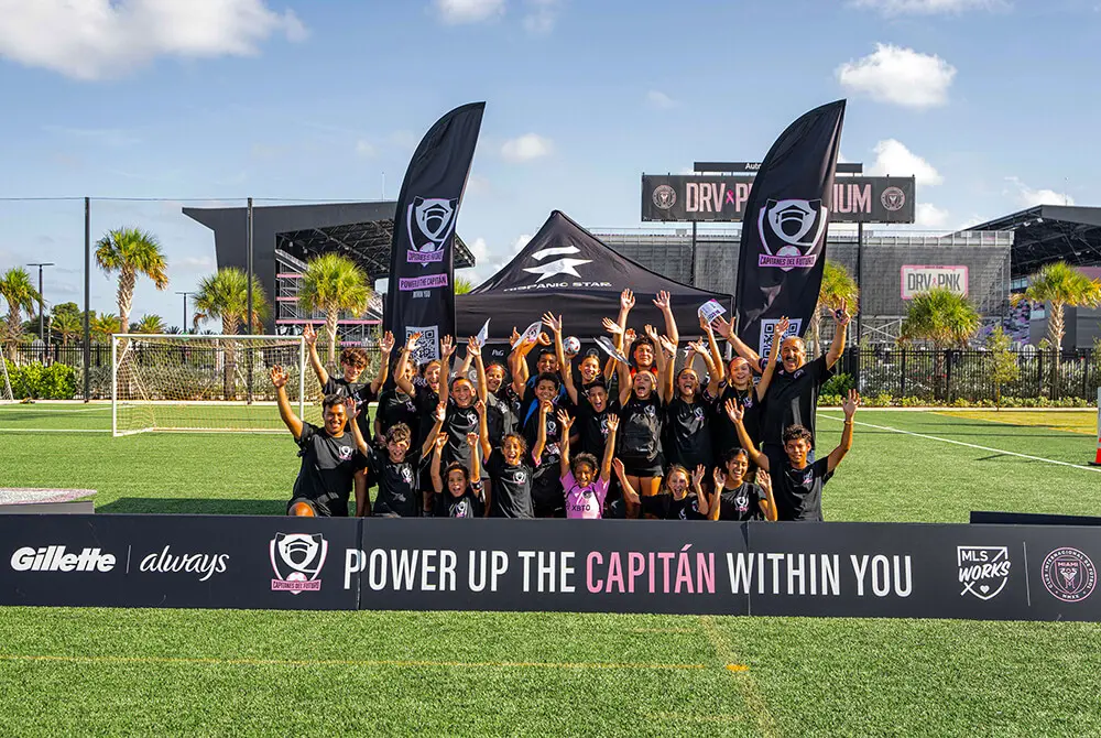 Group of young girls with sign that says "Power up the Capitan within you