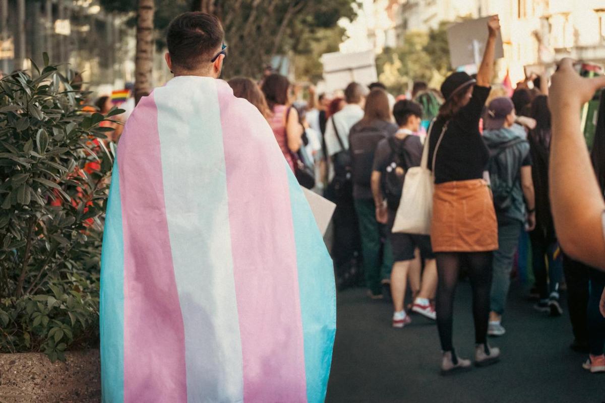 People at a Pride parade with transgender rights flag