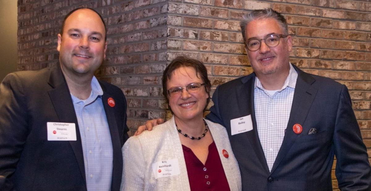Aramark Pride member Chris Stearns, with Kris Reinhardt and chair Ian Bailey.