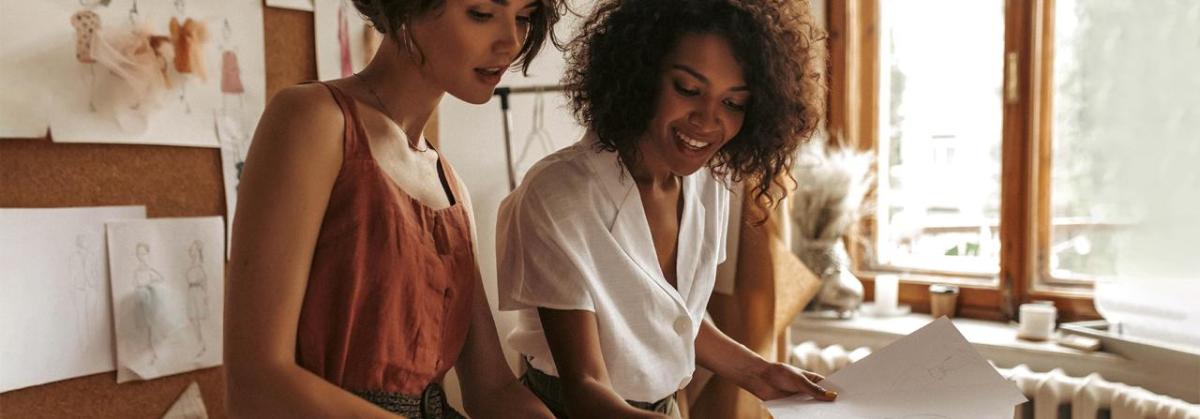 Two women working on a presentation.