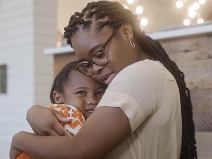 Photo of Perseverance Narcisse hugging her son.