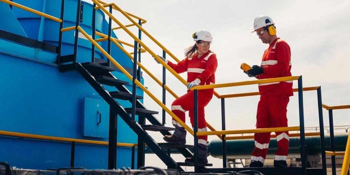 Two Veolia workers speaking to one another 