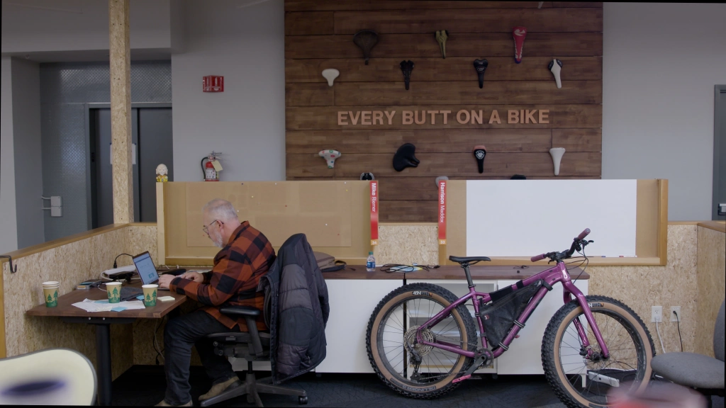 Person at office desk with bike next to them