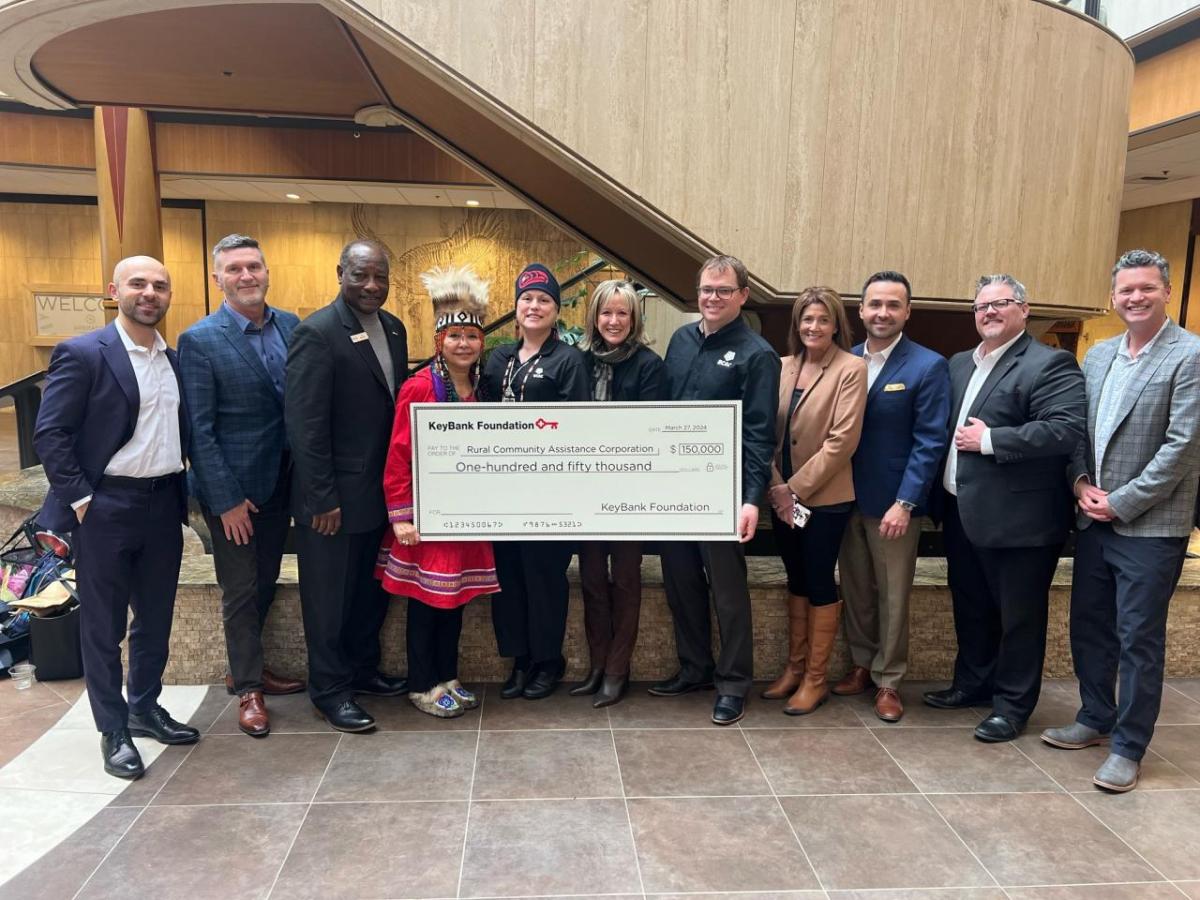 A group of people holding a large cheque