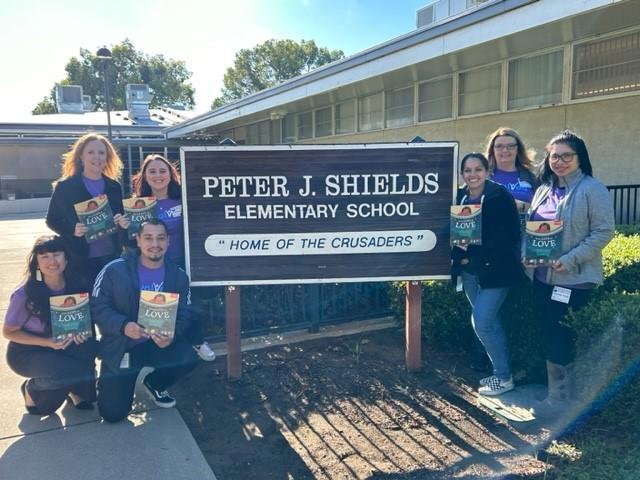 Rancho Cordova volunteers by elementary school entrance sign