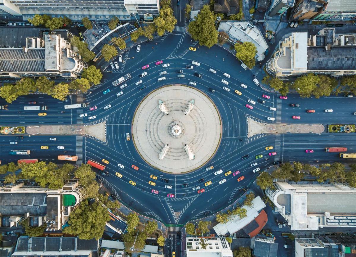 Aerial view of a busy roundabout in a city setting.