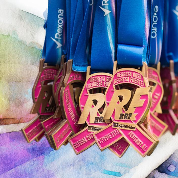 Many award medals in a bunch. RRF logo and pink ribbon medallion.