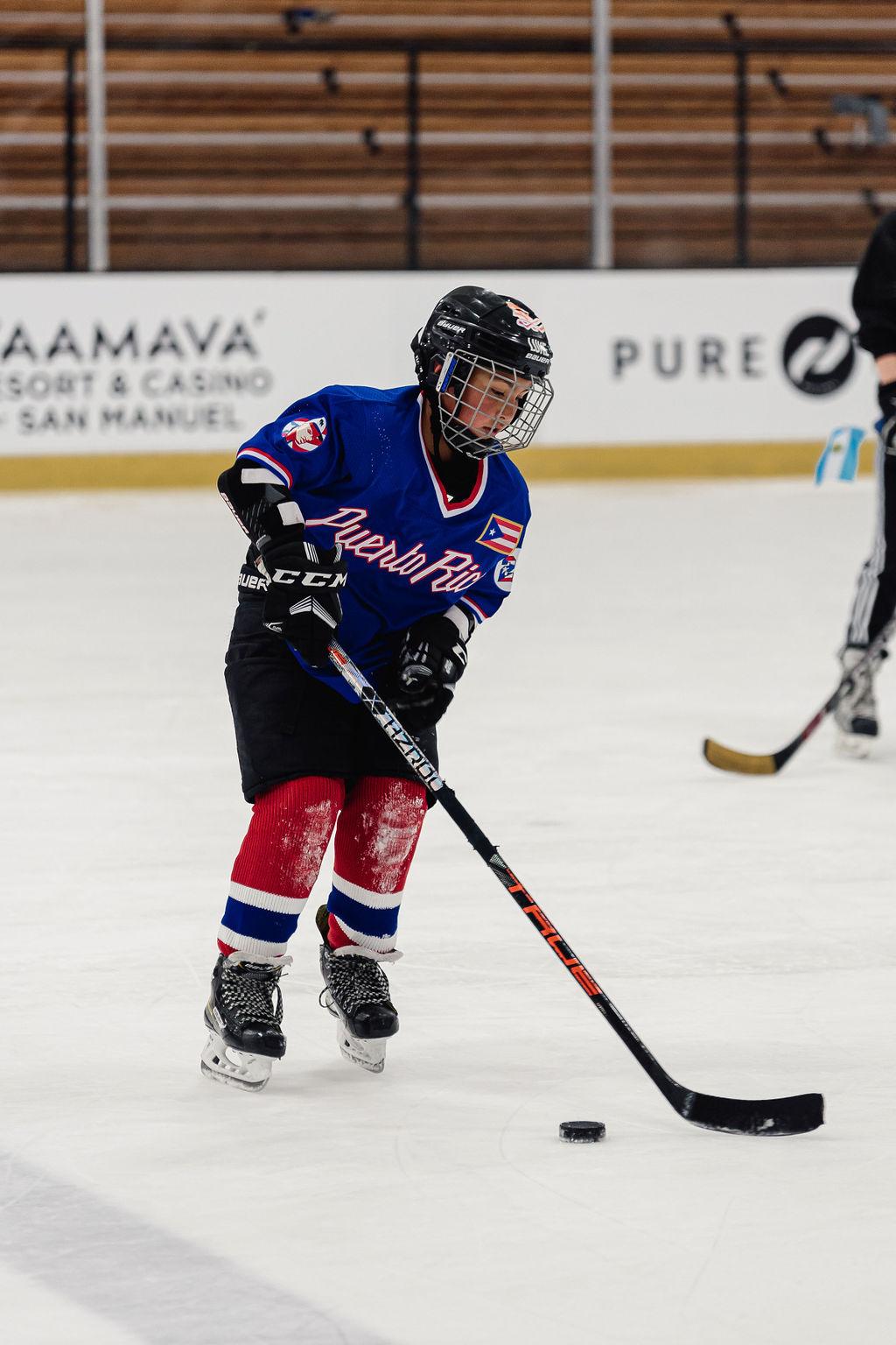 A child from 24 Degrees of Color plays on the ice in a jersey representing his heritage. Photo credit: Jason C Williams Photography