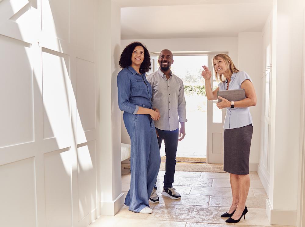 Real estate agent showing a couple a house