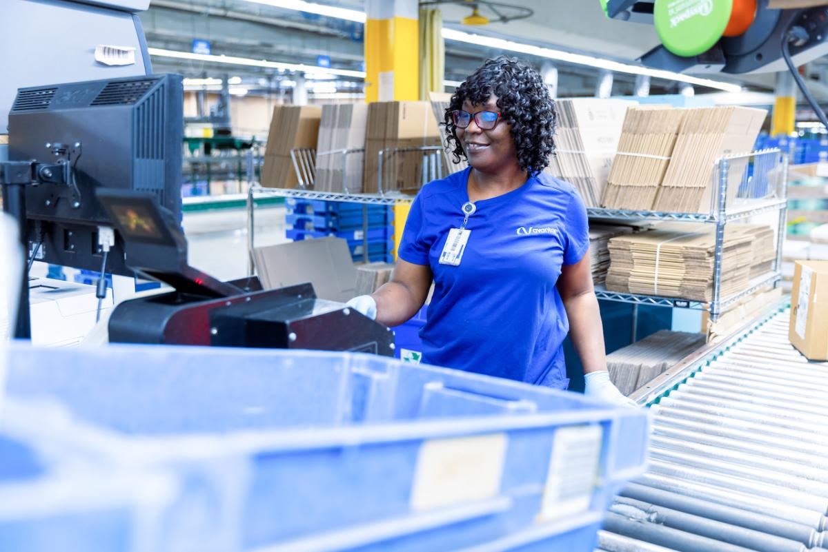 A female working in the packaging area of the Avantor warehouse.