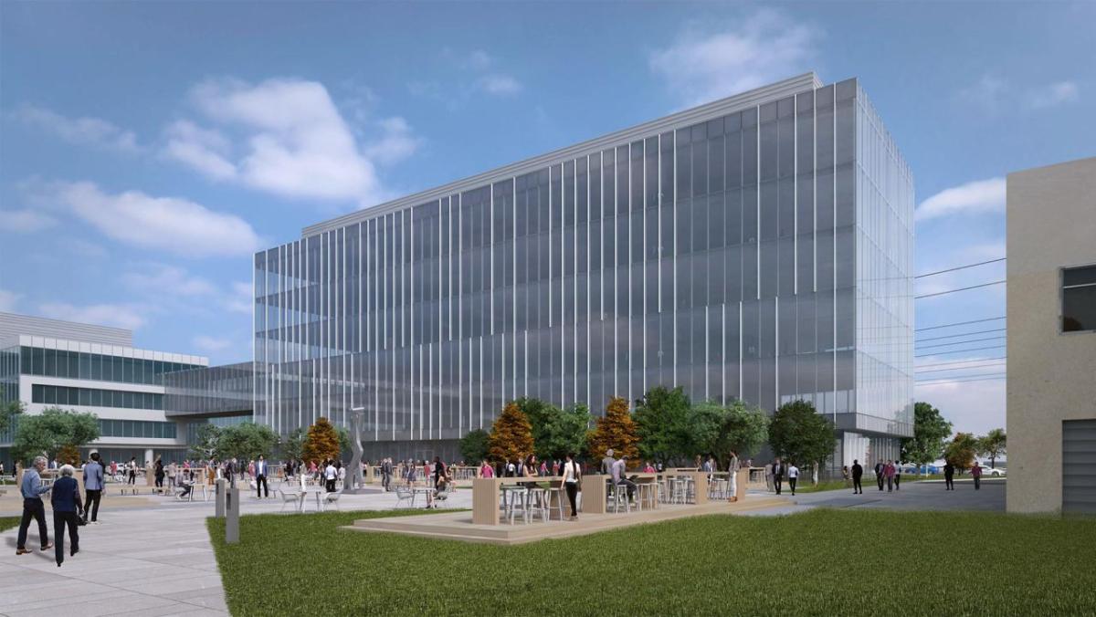 3D rendering of potential exterior of new research building. A large courtyard outside, walls covered in glass windows.