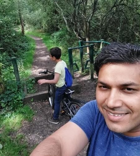 Sandeep shown with his son on a bike path.