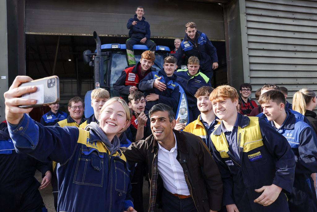 UK Prime Minister, Rishi Sunak, taking a photo with New Holland engineering apprentices 