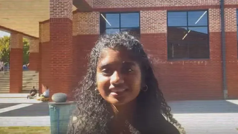 Image courtesy of FOX 5 Atlanta Photo of a student in front of a building