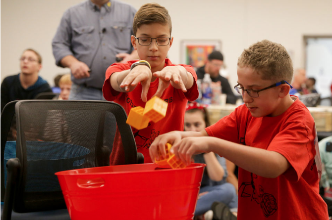 Sam MacMillan, 13, left, and Riley Marquedant, 13, act as robots during a simulation of the game challenge during the 2018 FIRST Tech Challenge Season Kickoff and Game Challenge Reveal, Saturday, Sept. 8, 2018, at Jackson College in Jackson. (Photo: Nikos Frazier/MLive.com)