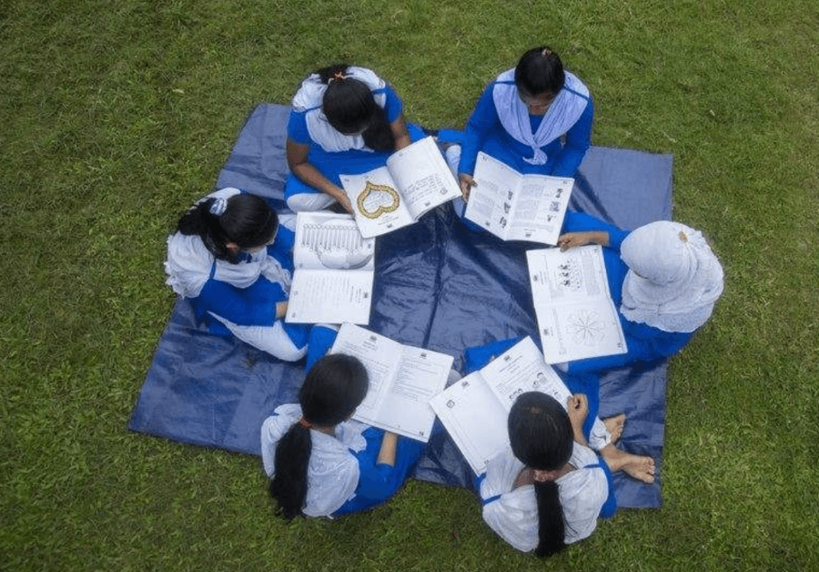 Gildan Extends its Partnership with Room to Read Bangladesh circle of girls reading