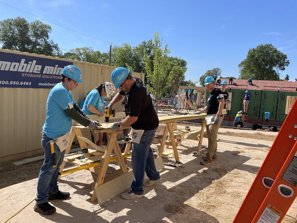 Wesco volunteers working on a house frame.
