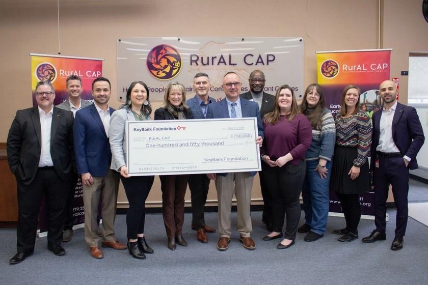 RurAl Cap and KeyBank representatives shown with a $150,000 grant check.