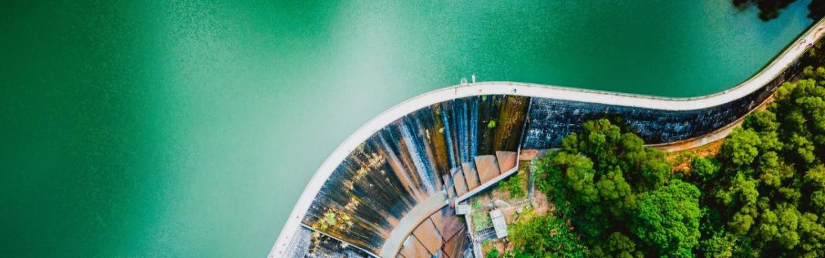 Aerial view of a body of water with a dam and walkway on top.