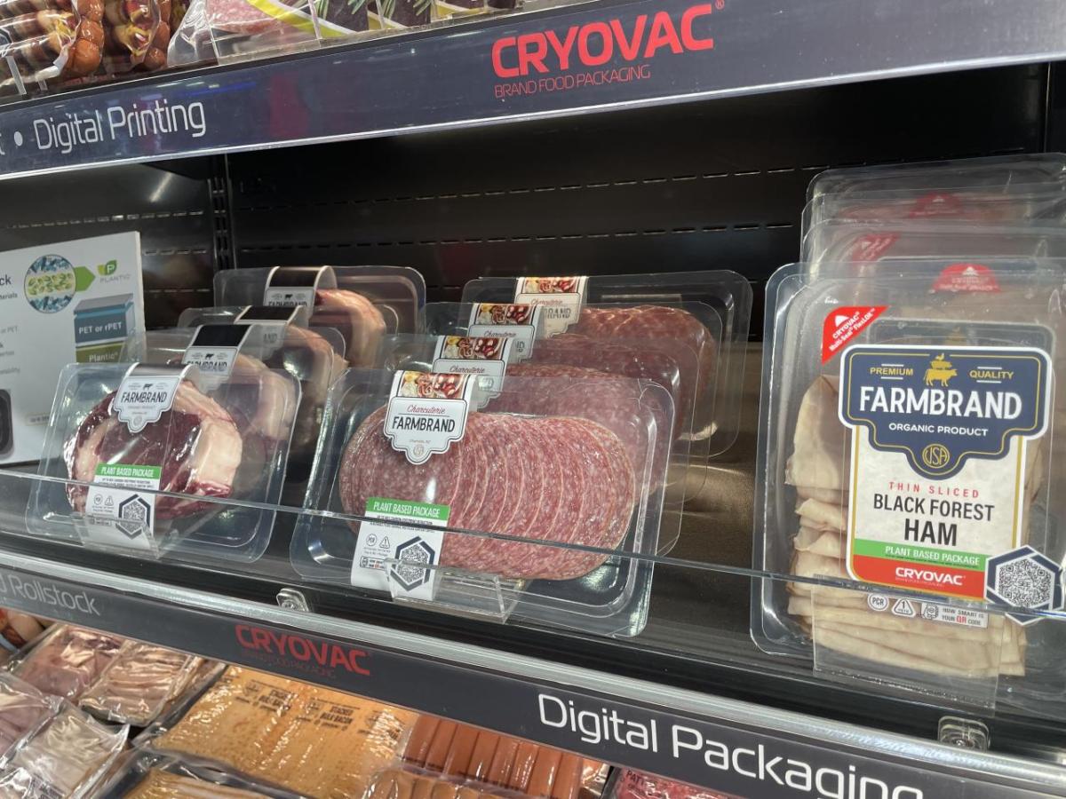 Various packages of fresh meats within a refrigerated case for retail presentation